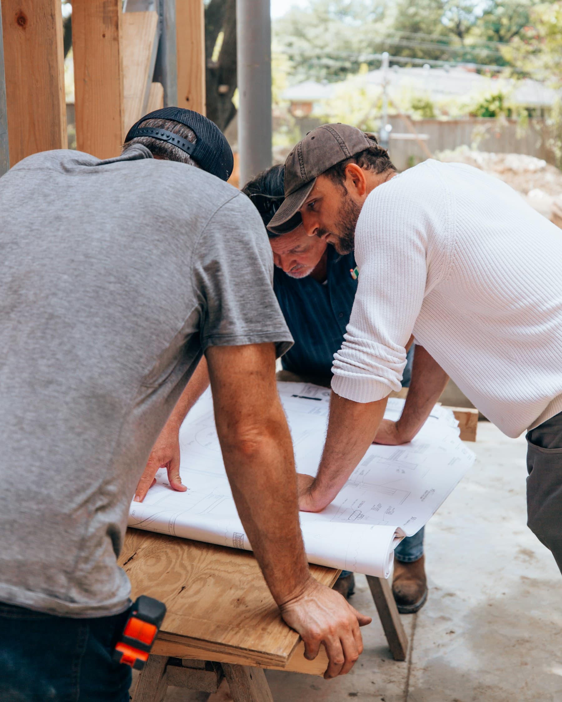 Construction professionals reviewing plans together at a jobsite