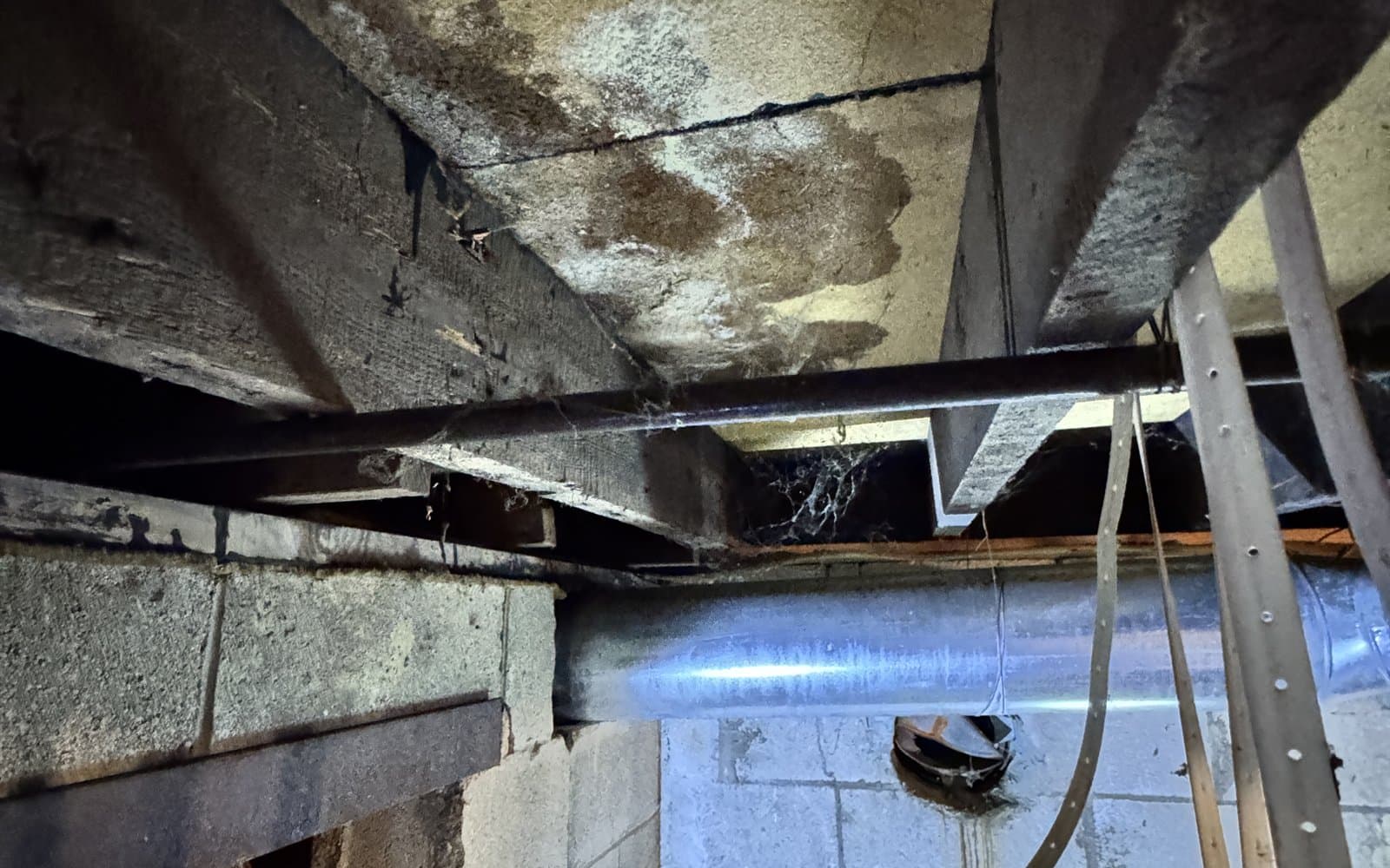 Water damage documented beneath a property